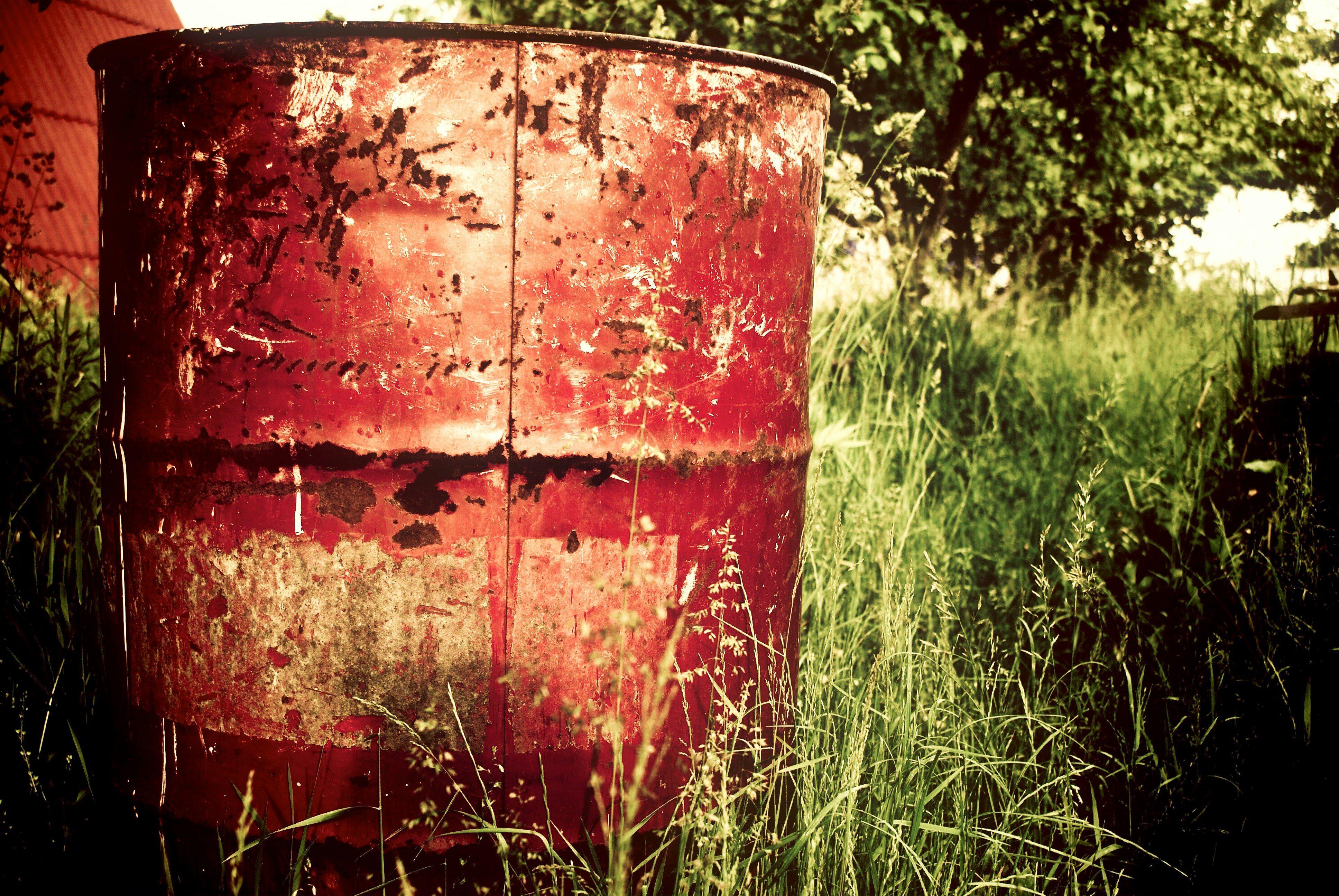 brown metal barrel on grass field